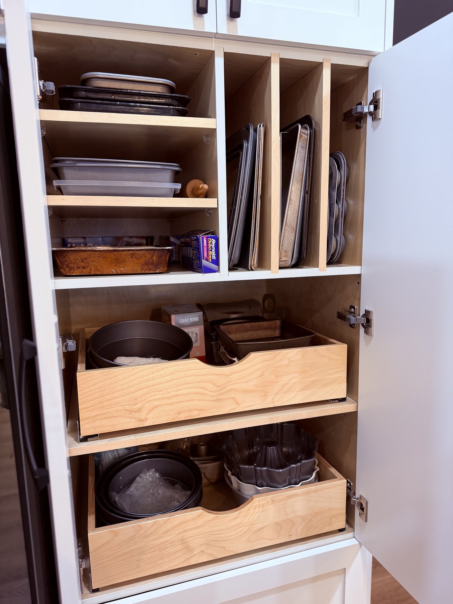 Installed cabinet showing Blum hinges and dovetail drawer boxes