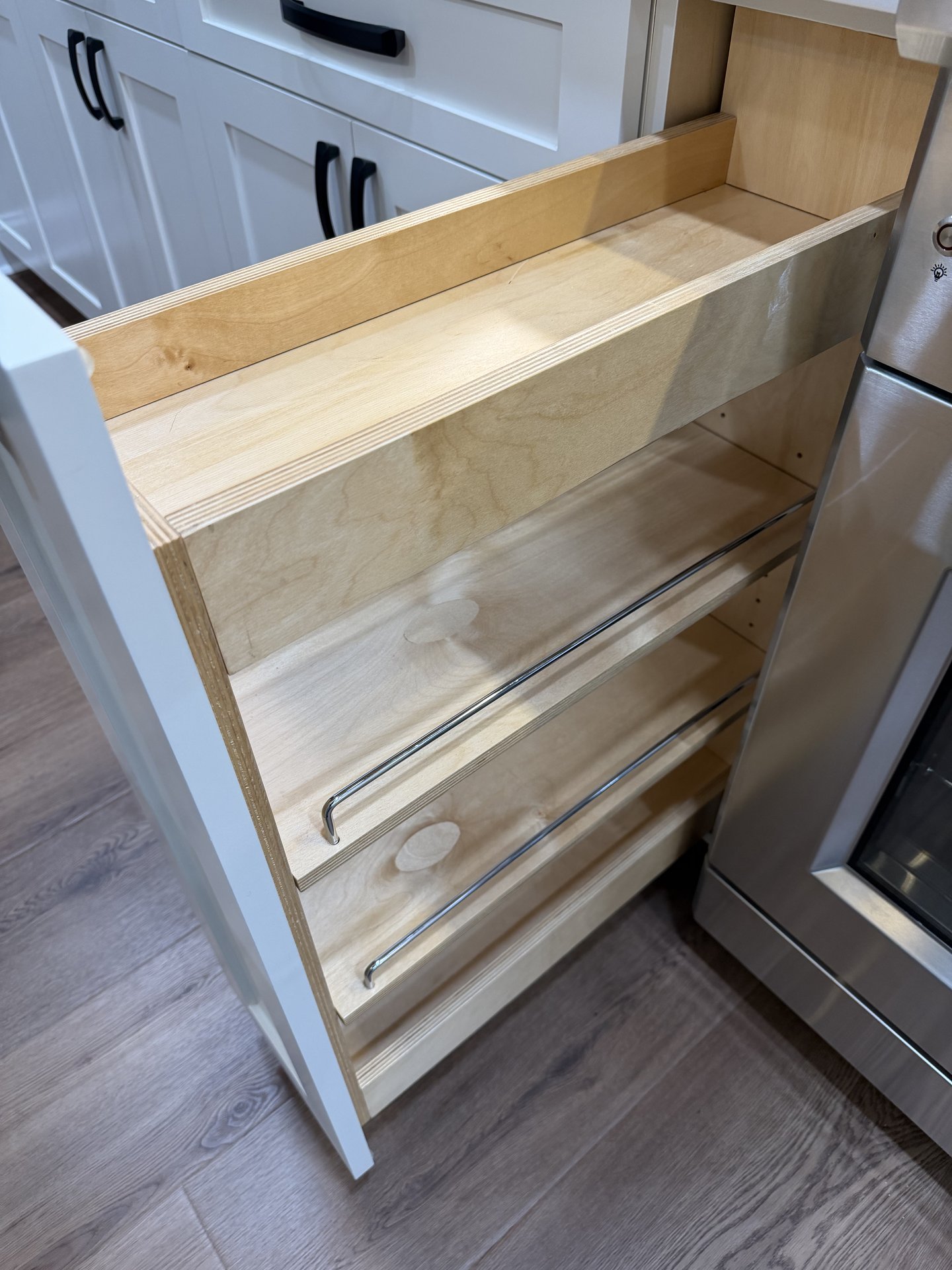 Built-in spice rack pullout inside a Hatley cabinet