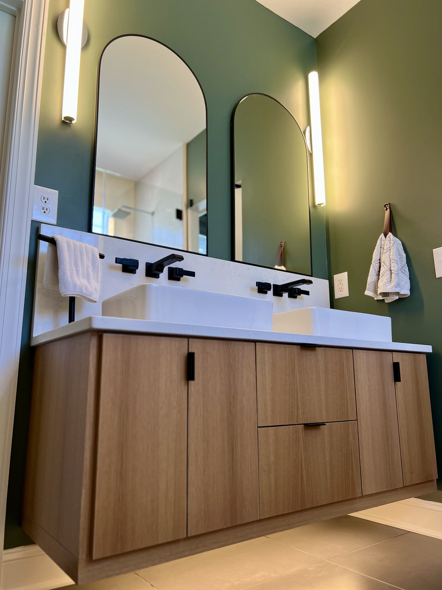 Modern oak slab vanity with green wall