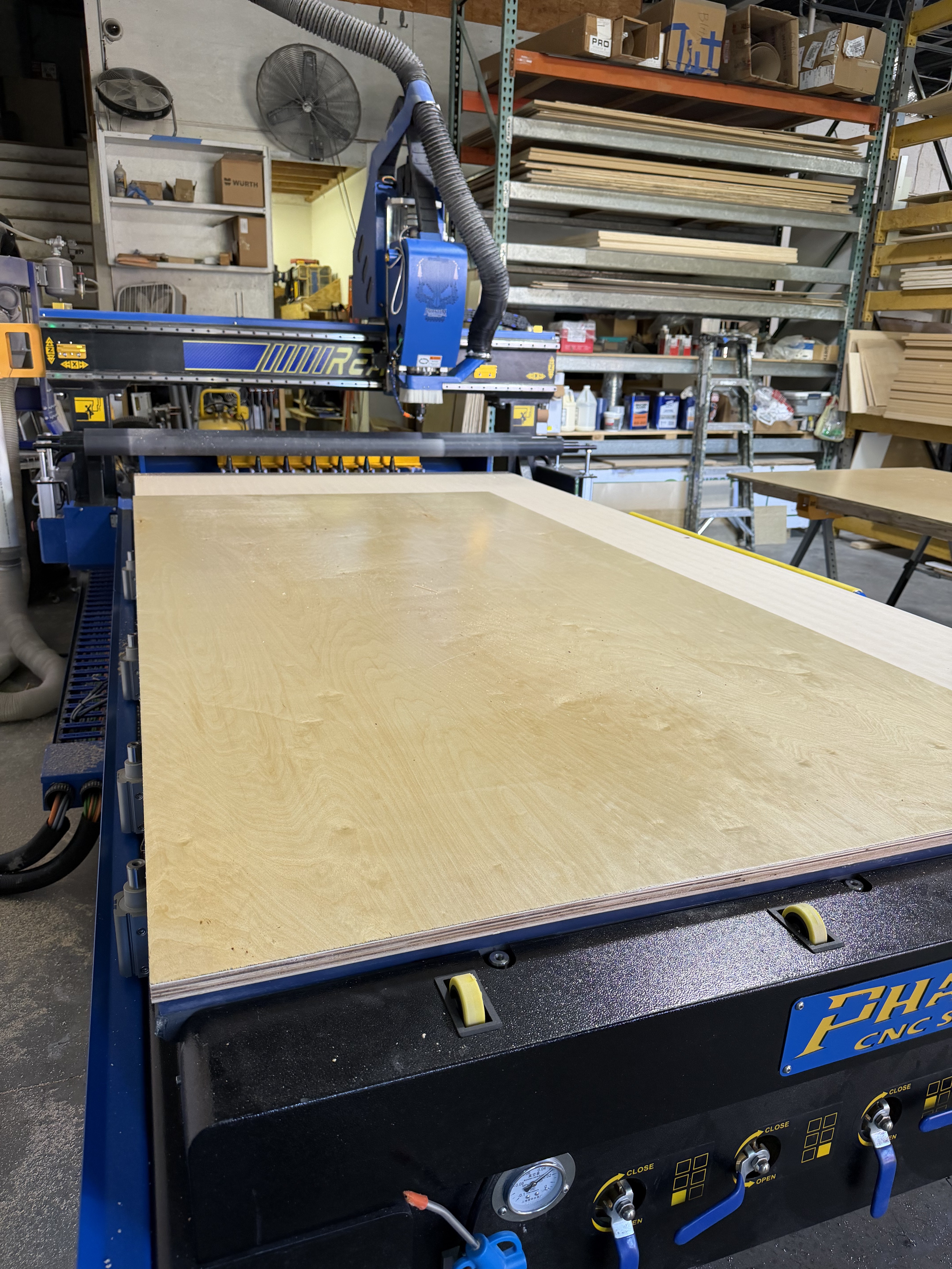 Blank plywood sheet loaded on the CNC ready to cut