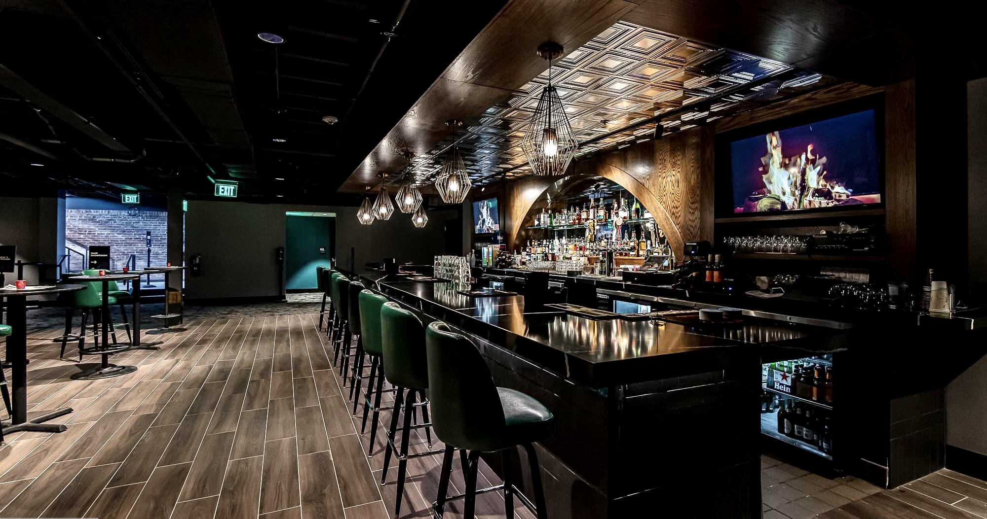 Custom bar build with ornate back bar dark wood and tin ceiling