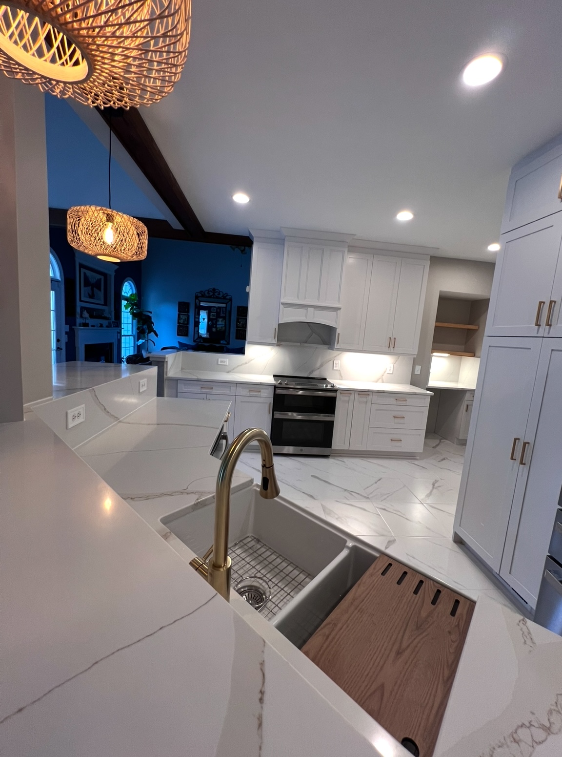 Open kitchen with rattan pendants, marble and brass